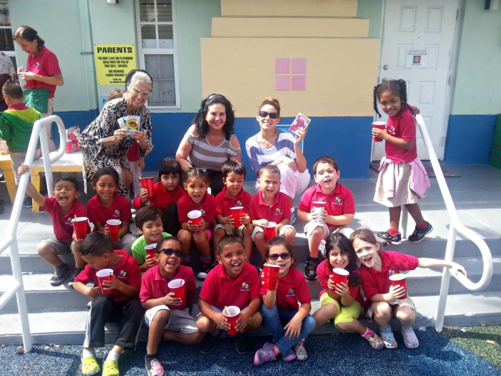 (Left to right) AYUDA Board Member Marjorie York, President/CEO Diana Susi, and Board Member Esther Dollar, celebrating Earth Day with the children of Happy Kids. Courtesy of AYUDAMiami.org